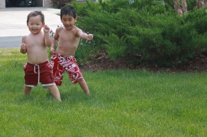 Michael and Alex getting reading to run through the long grass to jump into the swimming pool. 1 - 2 - 3 ... GO!